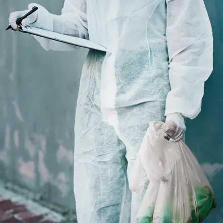 Hazmat worker going through crime scene cleanup checklist