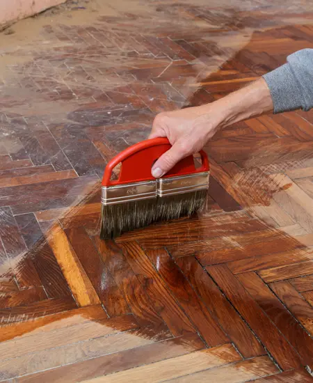 Applying varnish to wood floor