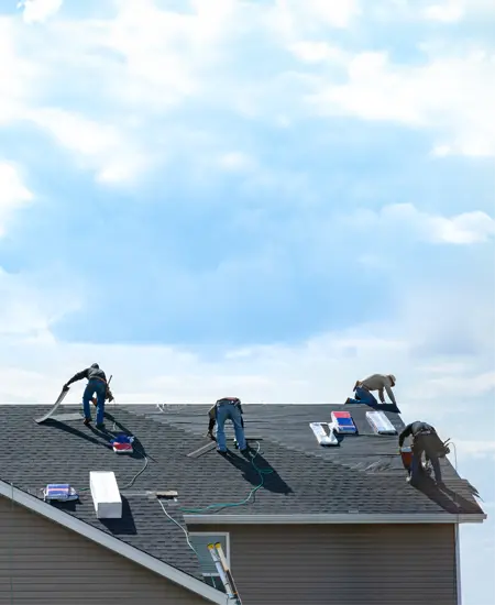 Group of people working on a roof repair